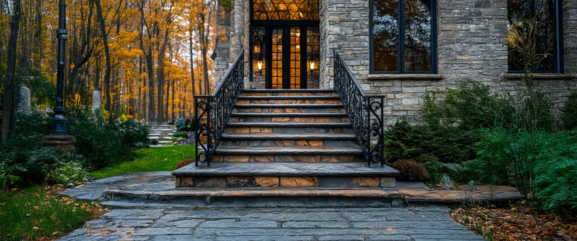 Elegant outdoor staircase with stone steps and decorative wrought iron railings.