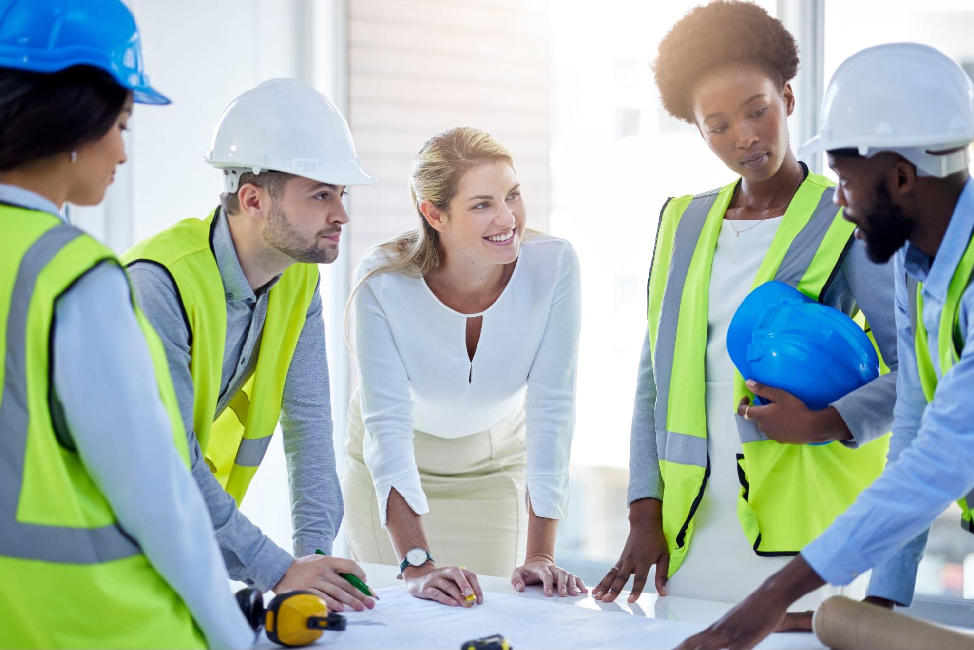 A general contractor coordinates with members of the team to plan their project.