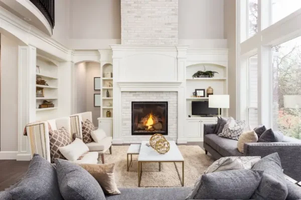 Beautiful Living Room in New Luxury Home with Fireplace and Roaring Fire.
