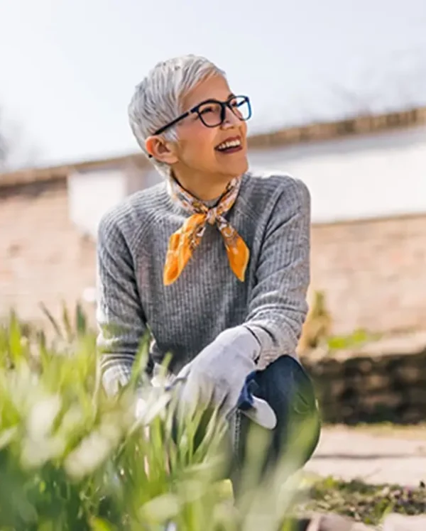 Happy senior woman gardening in the spring.