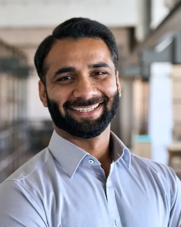 Happy smiling bearded indian business man small business owner.