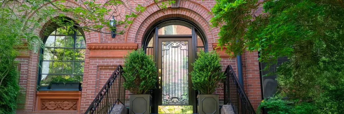 Harmony of nature and design at an elegant house entry with beautiful arched brick tuck pointing.