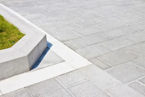 New carved paving made with grey stone blocks.