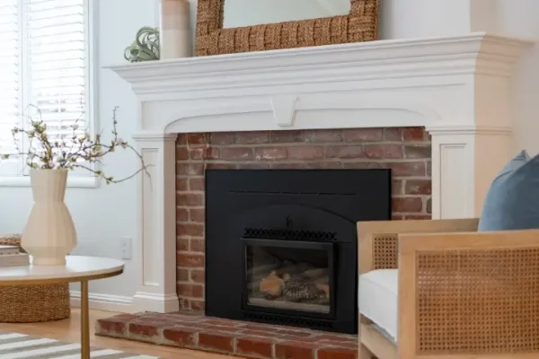 Original brick fireplace with new painted mantle and fireside seating.
