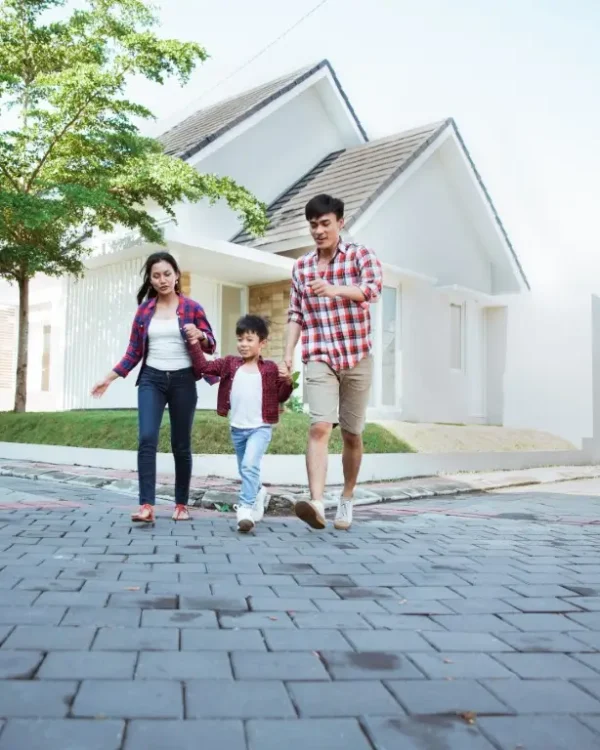 Family running around a brick road chasing each other while playing together at home.